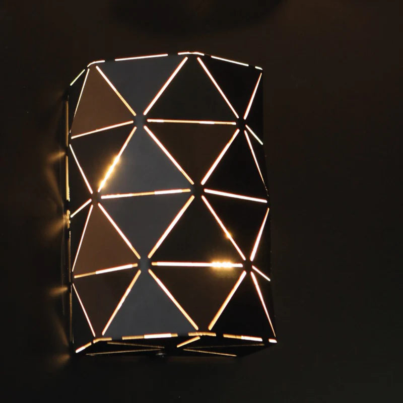 Laser-cut metal cylinder wall light.